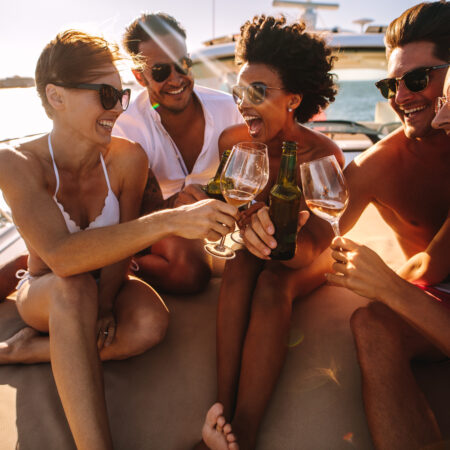 Multiracial,Group,Of,People,Toasting,Drinks,On,The,Yacht,Deck