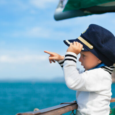 Funny,Little,Baby,Captain,On,Board,Of,Sailing,Yacht,Watching